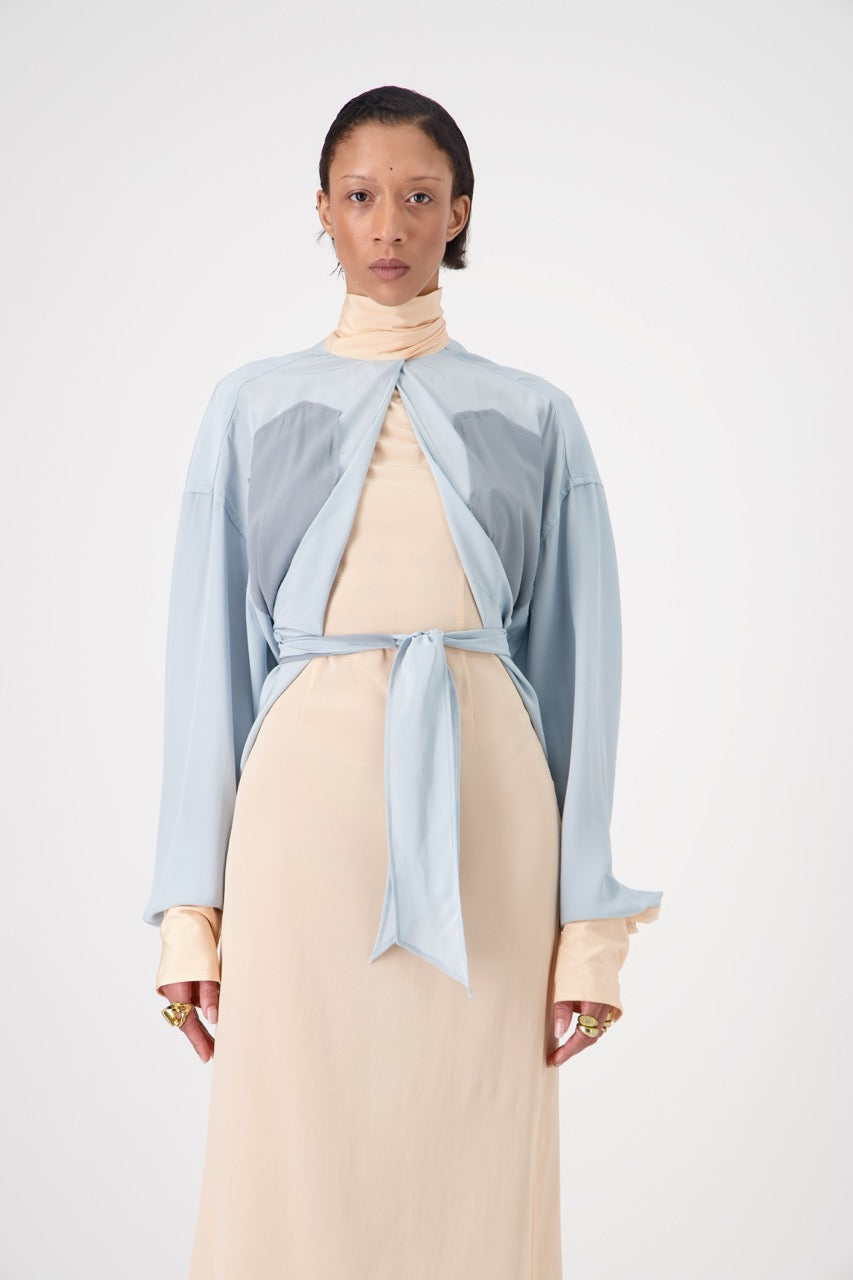 LAVA silk top with lavallière knot collar, front view on model, closed collar with hip knot