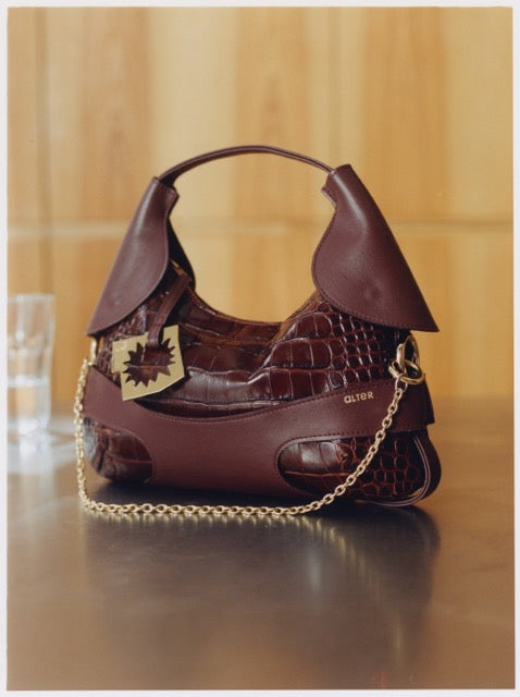 CULOTTE bag in leather, short-length, Alter Designs signature accessory, front view in store